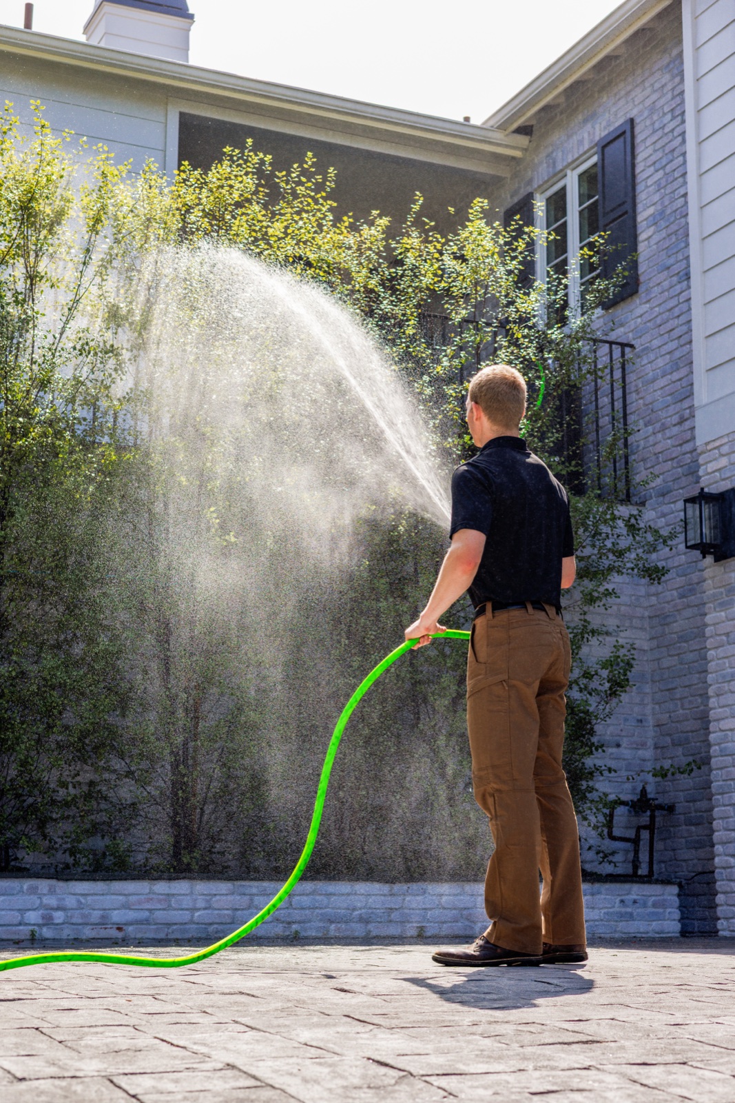 A Matador Fire technician coating a home in retardant